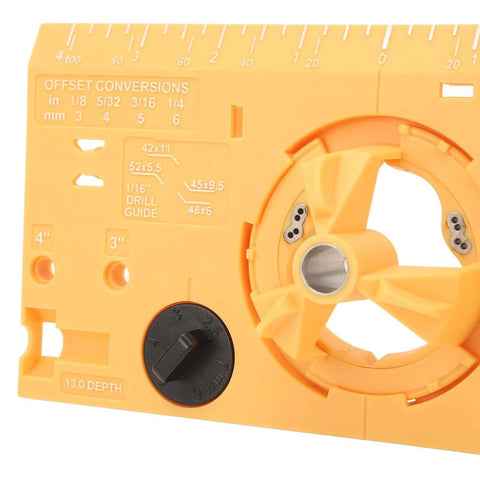 Front view of orange 35mm hinge boring jig kit for woodworking, with drill guide, ruler scale, and depth dial.