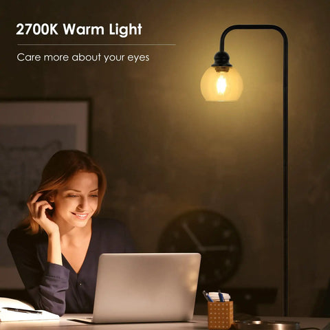 Cool Industrial Glass Globe LED Floor Lamp 63 Inch Tall Black Standing Reading Light illuminating a home office workspace.