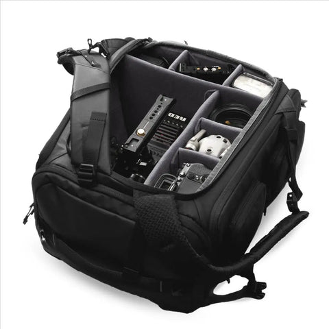 Cube Camera Backpack For Filmmakers And Photographers showing interior compartments with camera gear and drone storage.