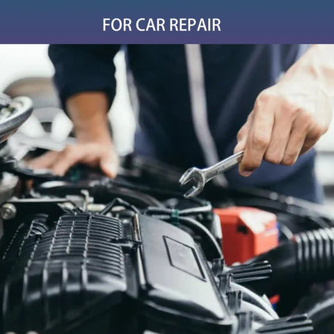Mechanic using a wrench on car engine for repair work
