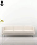 Modern living room with a white sofa and a camera powered by Two Pack 20Ft Power Extension Cable For Indoor And Outdoor Security Cameras Including Wyze Cam V4 V3 Pan OG Nest Cam Blink And Cloud Camera USB To Micro USB Charging And Data Sync Cord Plug And Play