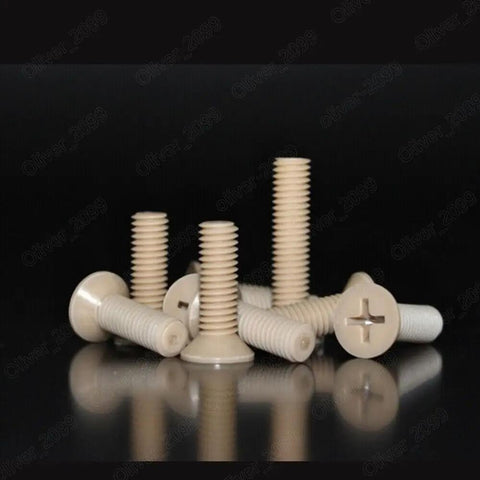 Premium PEEK Plastic Phillips Countersunk Flat Head Screws M6 X 40mm Pack Of Twenty shown in various angles on a reflective surface.