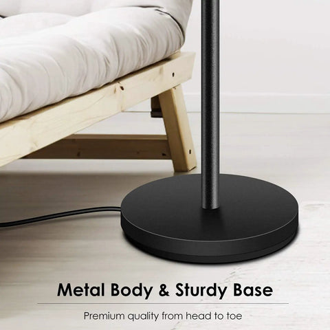 Base of Torchiere LED Floor Lamp 70 Inch Tall Stepless Dimmable Pole Lamp With 3600 Lumens At 3000K Warm Light Rotary Dial Switch Metal Modern Black Room Filling Brightness Standing Lamp For Living Room And Bedroom Cozy Vibes next to a wooden bed frame.