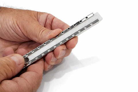 Person holding Welding Soapstone Refills 36 Pack For Metal Marking, Five Inches By One Half By Three Sixteenths Stones