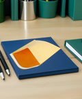 Kraft Paper Bubble Mailers 100 Pack Padded Envelopes 120x160mm on blue desk with stationery items