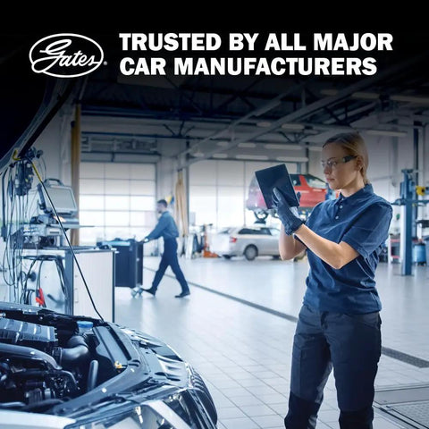 Mechanic inspecting under-hood setup, 50 Ft windshield washer and vacuum hose built road ready, workshop background.