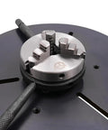 Heavy Duty Rotary Welding Positioner With Three Jaw Chuck, detailed view of the chuck mechanism on steel workbench.