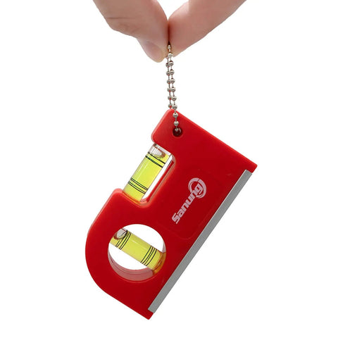 Two Piece Mini Magnetic Pocket Spirit Levels With Keychain And Storage Bag held in hand, showing red casing and glass vials.