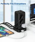 12 Outlet Surge Protector Power Strip With 4 USB Ports And A 10 Foot Cord in use at a desk, powering multiple devices, showing fireproof design.