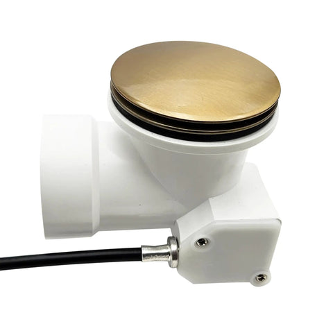 Top Shelf 35 Inch Cable Driven Bath Drain Trim Kit With Rotary Overflow Cover And Smooth Pop Up Stopper Featuring Schedule 40 PVC Construction And Slick Champagne Bronze Finish, close-up of bronze top and white PVC assembly.