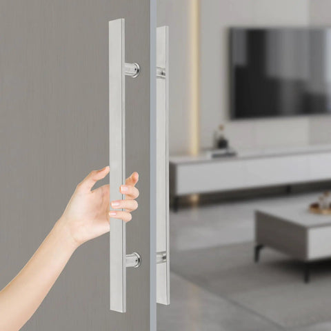 Double Sided 23.43 Inch Stainless Steel Barn Door Handle Bar Pull For Sliding Glass Shower And Entry Doors With A Grippy Ergonomic Back To Back Grip And Simple Push Pull Action For High Traffic Spaces. Close-up hand on double-sided stainless barn door handle