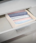 Foldable Beige Closet Storage Basket Straighten Your Space Fast Soft Polyester Cotton Linen Drawer Organizer For Socks Undies And Ties in a drawer with rolled clothes.