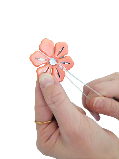 Hands using Magnetic Thread Cutter For Craft And DIY Sewing Flower Shape Yarn Cutter Super Handy Sewing Tool