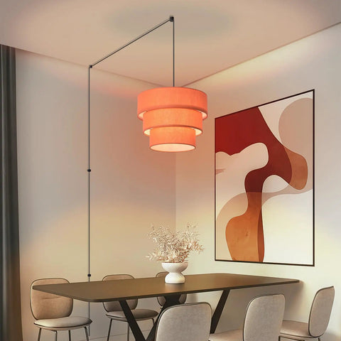 Orange Plug In Pendant Light With Three Tier Mid Century Modern Linen Shades Stylish Hanging Chandelier above a dining table.
