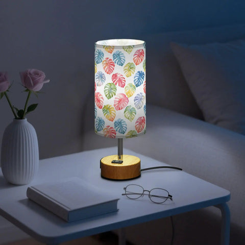 Watercolor Monstera Leaf Palm Decor Bedside Lamp With Three Way Dimmable Touch Control And Built In Charging Station on nightstand