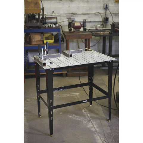 Hot Welding Table Clamp Kit 4 Pieces Perfect For 16mm Holes on a sturdy welding table, ready for secure metalwork setup.