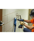 Professional 18V Brushless Hammer Drill Driver Kit With 8 Ah Battery Pack And 1330 Inch Pound Torque used by worker drilling into wall.