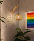 Hand Woven Bamboo Lantern Wall Sconce With Plug In Cord Wicker Rattan Farmhouse Rustic Boho Lighting For Living Room And Bedroom Cast Warm Decorative Light Patterns And Features A Solid Wood Holder illuminating a room corner.