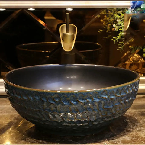 USZWBY Vessel Sinks Bathroom Vessel Sink Round Ceramic Washbasin with a textured dark blue finish, ideal for elegant bathrooms.