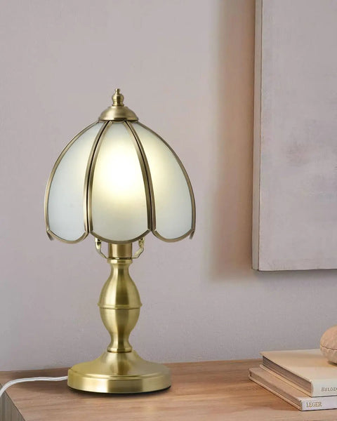 Retro Mushroom Table Lamp With Frosted Glass Shade And Brass Base on a wooden nightstand.