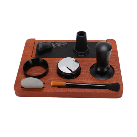 Solid Wood Espresso Tamper Station With Silicone Mat And Seven Piece Barista Gear Featuring Spring Loaded Hand Tamper Distribution Tool Dosing Ring Stainless Puck Disc And Detail Brush For Dialing In Perfect Home Brews Every Time on a wooden tray.