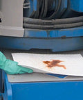 Heavyweight Oil Absorbing Pads For Garage Workshop Clean Up Oil Only Absorbent Mats 15 X 20 Inches being used to soak up oil leak.