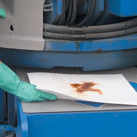 Heavyweight Oil Absorbing Pads For Garage Workshop Clean Up Oil Only Absorbent Mats 15 X 20 Inches being used to soak up oil leak.