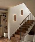 Feasey Set of 2 Walnut Wood Wall Sconce, Vintage Wall Mounted Light Fixture illuminating a stairwell with warm light.