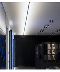 Effortlessly Sleek Modern Linear LED Wall Sconces With Remote Control For Cozy Bedroom And Living Room Vibes A Total Game Changer For Your Glow Up In Black Finish Dimmable Lighting, illuminating a stylish gallery space.