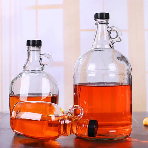 12 Pack 38mm Growler Caps With Durable Poly Seal Lids for Half Gallon and One Gallon Glass Jugs Replacement Tops for Homebrew Beer and Wine Making For Your Brew Scene Black, shown sealing orange liquid in glass jugs of varying sizes.