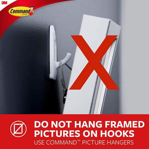 A wall with a white XL hook, showcasing incorrect usage with a frame, emphasis on proper wall mounting solutions.