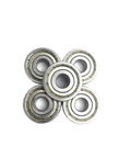 Check Out These Awesome 2 Pack Of 6205ZZ Deep Groove Ball Bearings Measuring 25 By 52 By 15 Millimeters With Abec Three Precision Rating Designed For Heavy Duty Industrial Drilling Applications That Need To Get It Done Without Any Wobbling Or Friction - stacked view of five metal ball bearings.