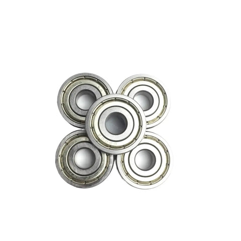 Check Out These Awesome 2 Pack Of 6205ZZ Deep Groove Ball Bearings Measuring 25 By 52 By 15 Millimeters With Abec Three Precision Rating Designed For Heavy Duty Industrial Drilling Applications That Need To Get It Done Without Any Wobbling Or Friction - stacked view of five metal ball bearings.