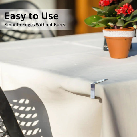 Rustproof Stainless Steel Tablecloth Clips 12 Pack For Outdoor Picnics And Parties, securing a tablecloth at an outdoor setting.
