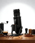 Next Level Heavy Duty Aluminum Conical Burr Coffee Grinder With Sixty Exact Settings, black coffee grinder with ground coffee nearby.