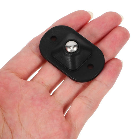 4pcs Small Furniture Adhesive Swivel Caster Wheels held in hand, showcasing black material and ball bearing design for easy installation.