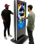 Two men interacting with a Dual Side Interactive Touch Screen Kiosk, packed with Android 14 signage features, in a retail setting.
