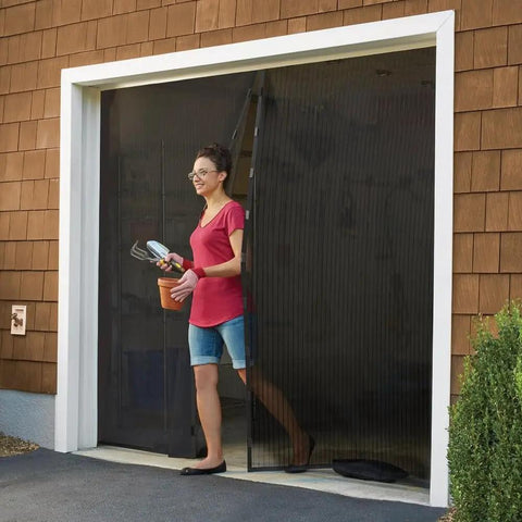 Hands Free Magnetic Door Screen For Double Doors Keeps Bugs Out And Fresh Air In Easy Install Mosquito Net For French And Sliding Doors Kid And Pet Friendly Black Size 109 By 84.5 Inches. Installed on garage door with person walking through.