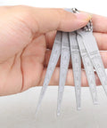 Hand holding Pro Grade Welding Space Measuring Tool Set with steel feeler gauges, tapered design, five graduated sizes