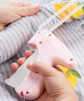 No Sweat Heavy Duty Handheld Sewing Gun Quick Clothing Repair Tool Featuring Pink Grip in use on fabric.
