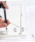 Installation of 20 Sets Furniture Connecting Cam Fittings Kit Connectors Dowels For Cabinets with screwdriver on white panel
