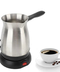 Electric Coffee Pot With Ergonomic Handle 600 Milliliter Stainless Steel Turkish Coffee Maker Kettle next to coffee cup