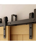 Close-up of installed Two Door Sliding Barn Door Hardware Kit With Bypass Track System, featuring J shaped rollers on wood doors.