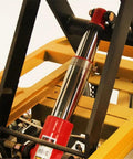 Close-up view of hydraulic cylinder on Heavy Duty Hydraulic Lift Table And Four Wheel Manual Push Platform for pallet handling.
