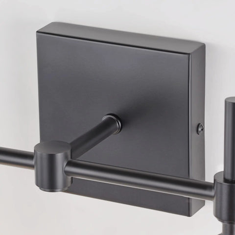 Close-up of matte black backplate and arm of Three Light Black Vanity Light Fixture Over Mirror With Clear Glass Shades