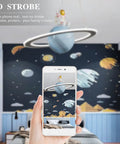Space Themed Astronaut Pendant Light For Kids Room Dimmable Planet LED Chandelier With 3000K 4000K And 6000K Color Temperatures 19 Inch 40W Nursery Toy Room Decor displayed on a smartphone in a space-themed room