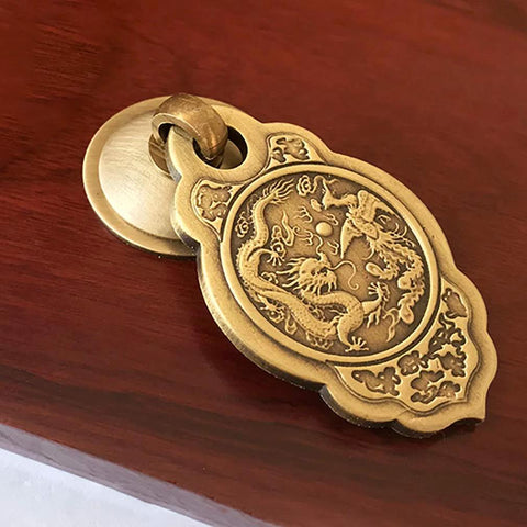 Chinese Style Vintage Brass Drawer Pulls Set Of 2 With Antique Bronze Finish on wooden surface, ornate dragon design