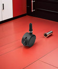 4pcs Inch Swivel Caster Wheels Brake for Furniture, black plastic swivel caster on red floor, showcasing brake feature.