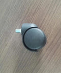 Slick Black Twin Wheel Swivel Casters With M10 Threaded Stem showcasing a 2-inch plastic wheel on a wood surface.