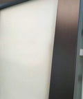 Close-up of the black matte frame and frosted glass panel of the Interior Sliding Barn Door With Frosted Glass, Solid Wood Construction, 32x84 Inches, Black Modern Style, Hardware Included Kit With Steel Rail, Hangers, Floor Guide, Door Stop And Anti Jump Pins For Smooth, Quiet Sliding.